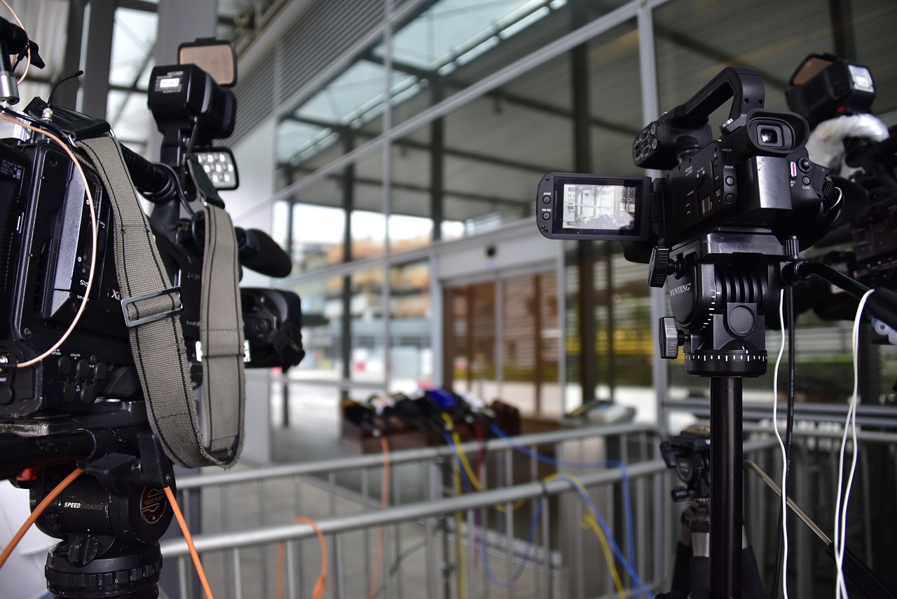 Press-style camera and lighting equipment suggesting signal discipline and documentation rigor